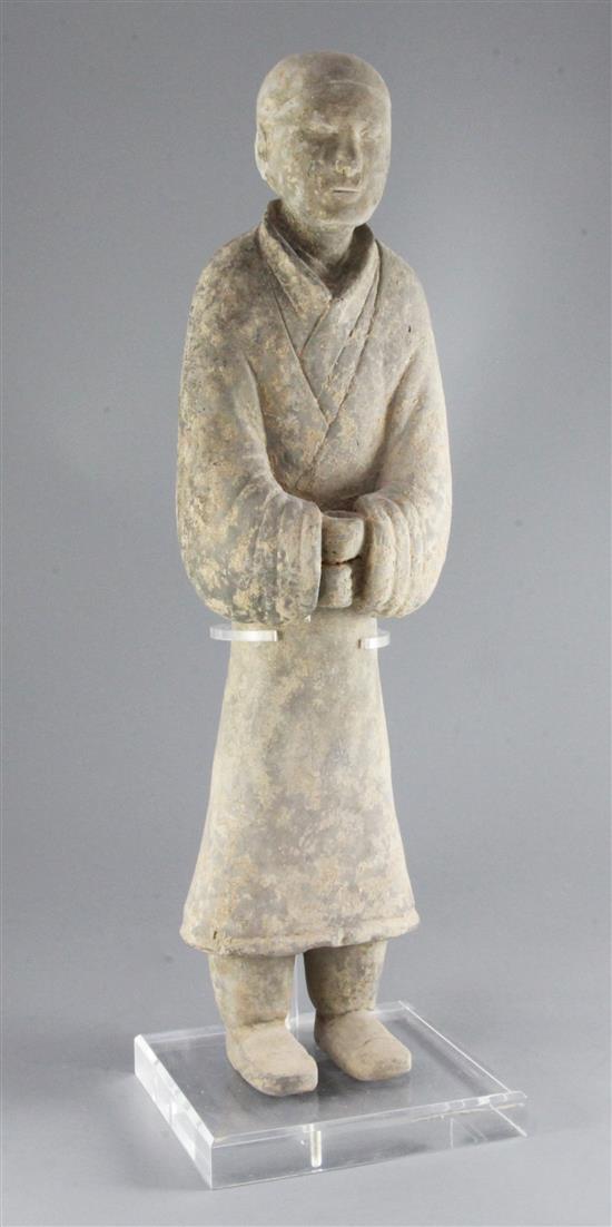 A large Chinese grey pottery standing figure of a civil official, Western Han dynasty (206BC-9AD), height 58cm, modern stand
